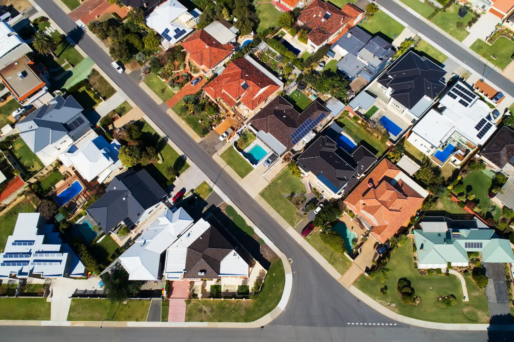 Hand on calculator with coins and laptop — blog cover image for The Tax Benefits of Investment Properties