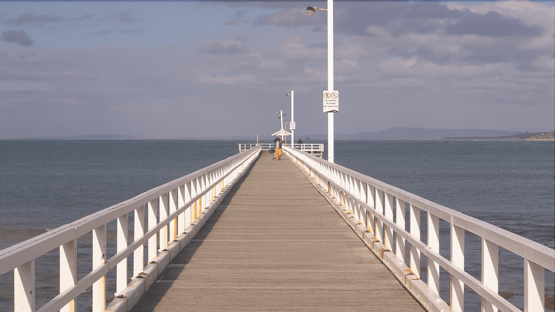 Pier leading out to the ocean symbolising